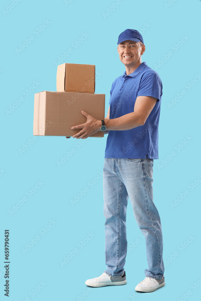 Mature courier with parcels on blue background