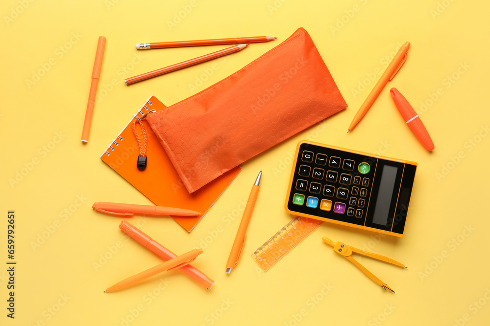 Orange pencil case with school stationery on beige background