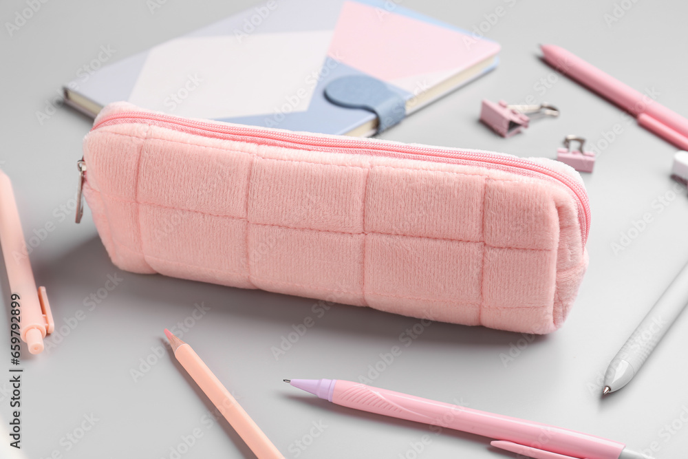 Pencil case with school stationery on grey background, closeup