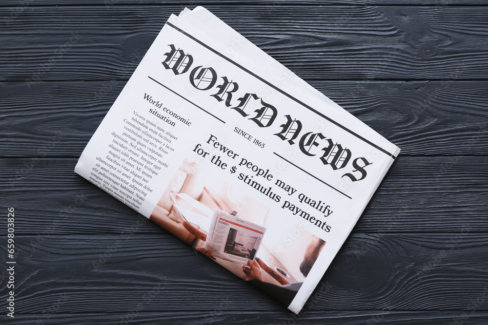 Morning newspaper on black wooden background