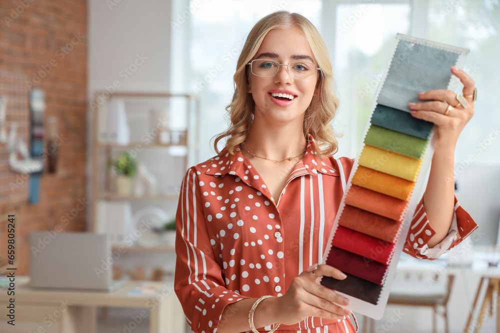 Female interior designer with fabric samples in office