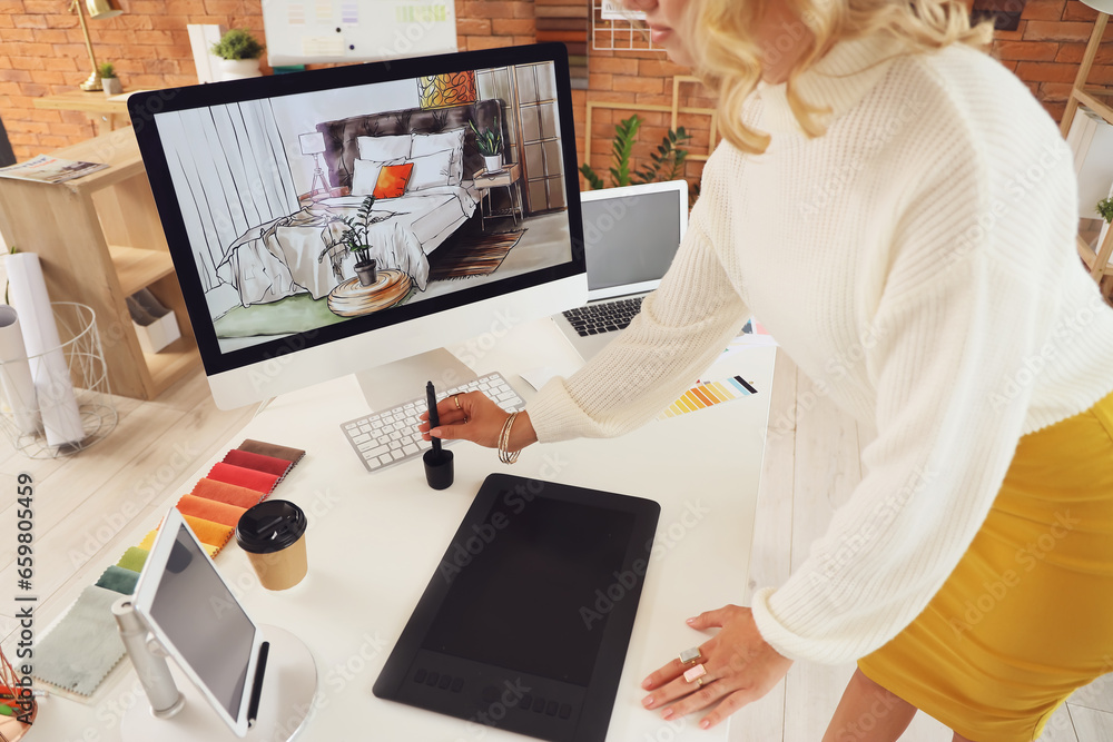 Female interior designer working with graphic tablet in office, closeup