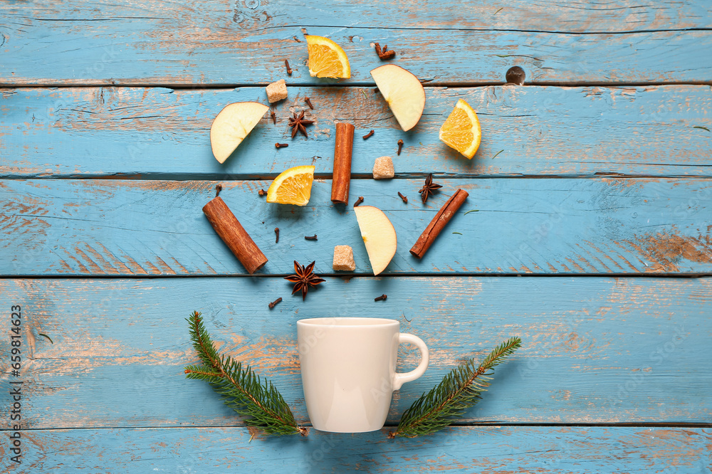 Ingredients for preparing tasty mulled wine and cup on blue wooden background