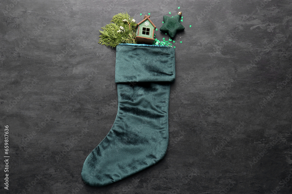 Beautiful Christmas sock with decorations on black background