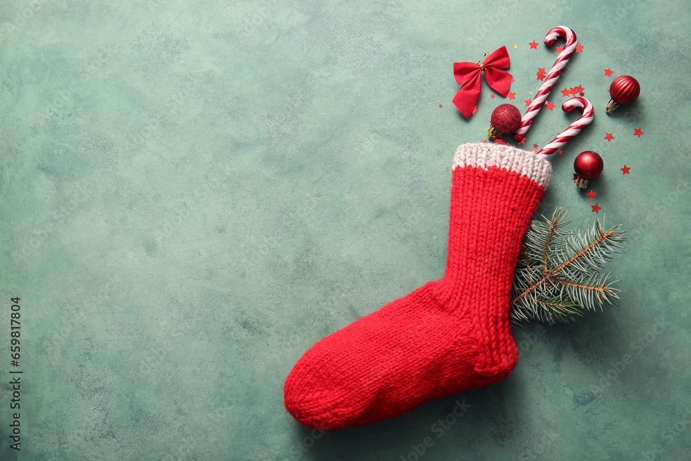 Beautiful Christmas sock with decorations on green background