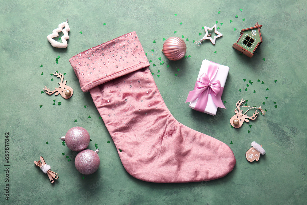 Beautiful Christmas sock with gift box and  decorations on green background