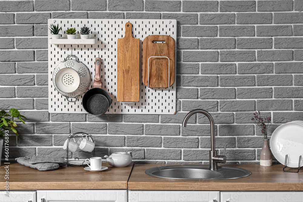 Modern kitchen with pegboard, sink and utensils