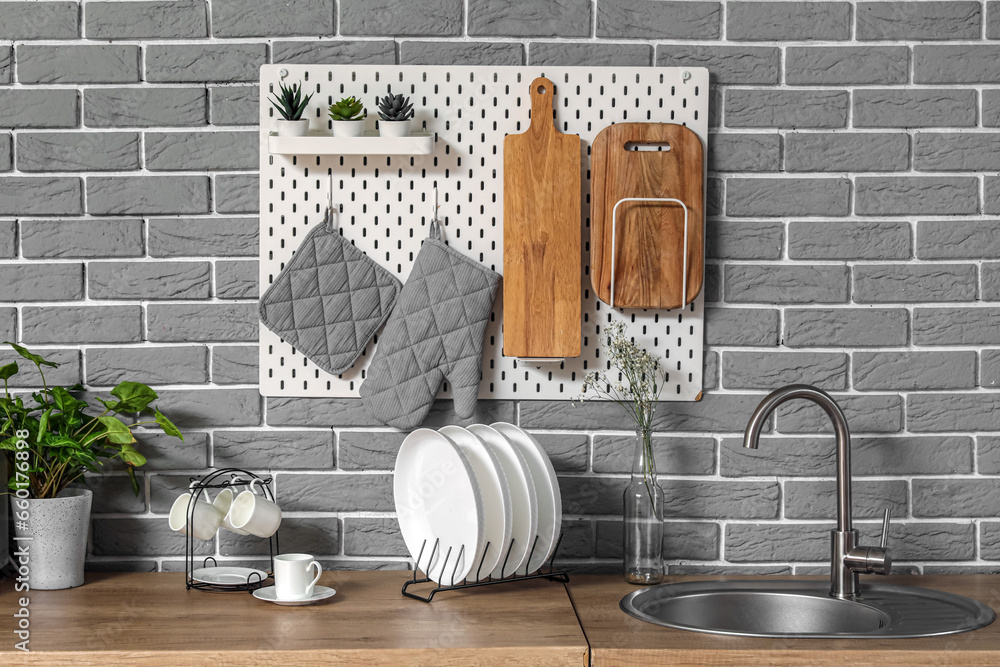 Modern kitchen with pegboard, sink and utensils