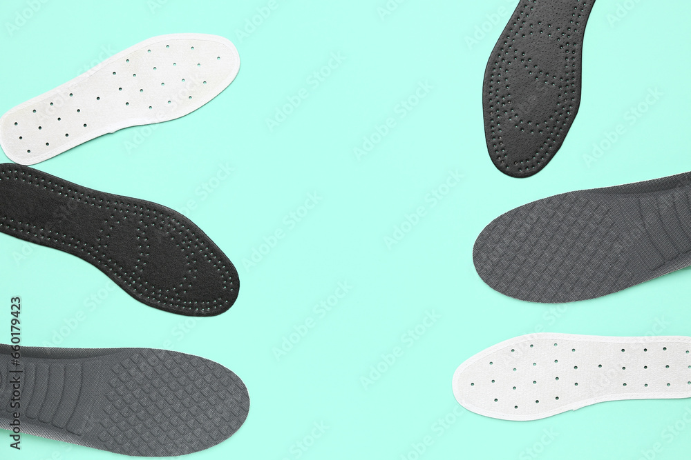 Composition with different orthopedic insoles on color background