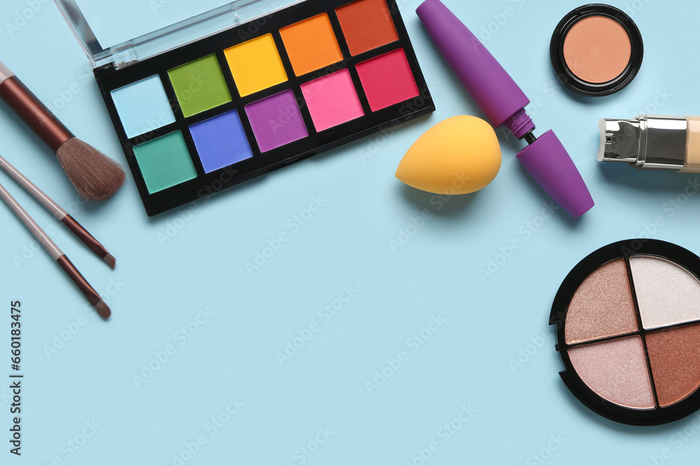 Set of decorative cosmetics and makeup sponge on color background