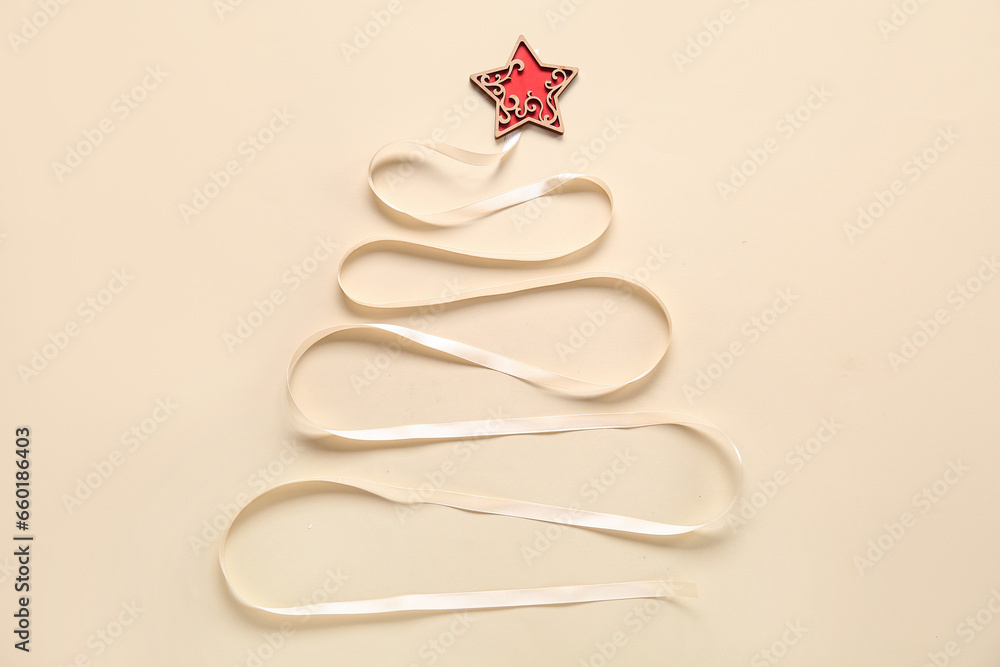 Christmas tree made of wooden star and ribbon on beige background