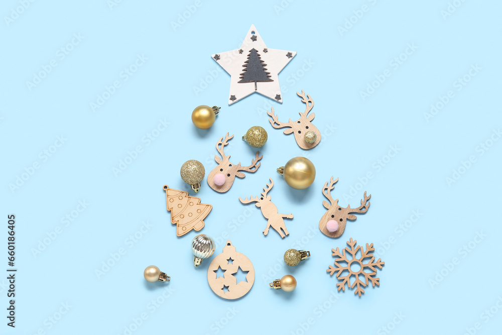 Christmas tree made of wooden toys and balls on blue background