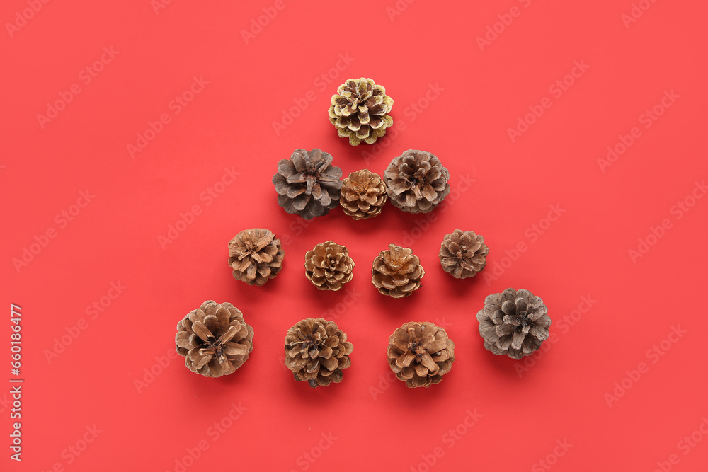 Christmas tree made of cones on red background