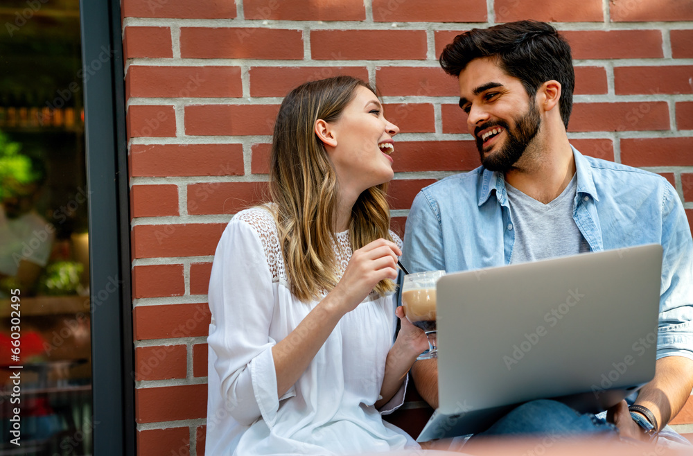 Happy young couple working studying on laptop and digital devices. Business education people concept