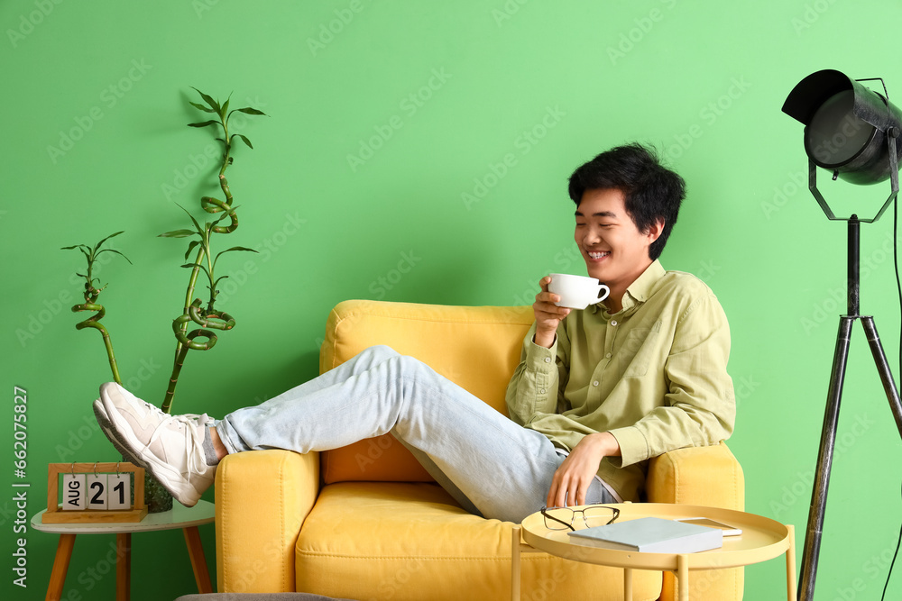 Young Asian man drinking coffee on his day off at home