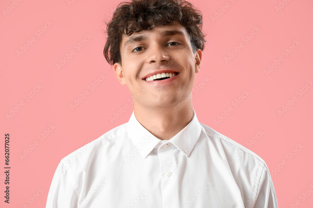 Portrait of handsome young man on pink background