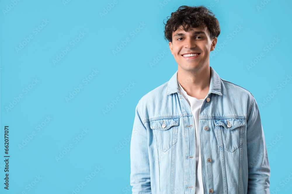 Portrait of handsome young man on blue background