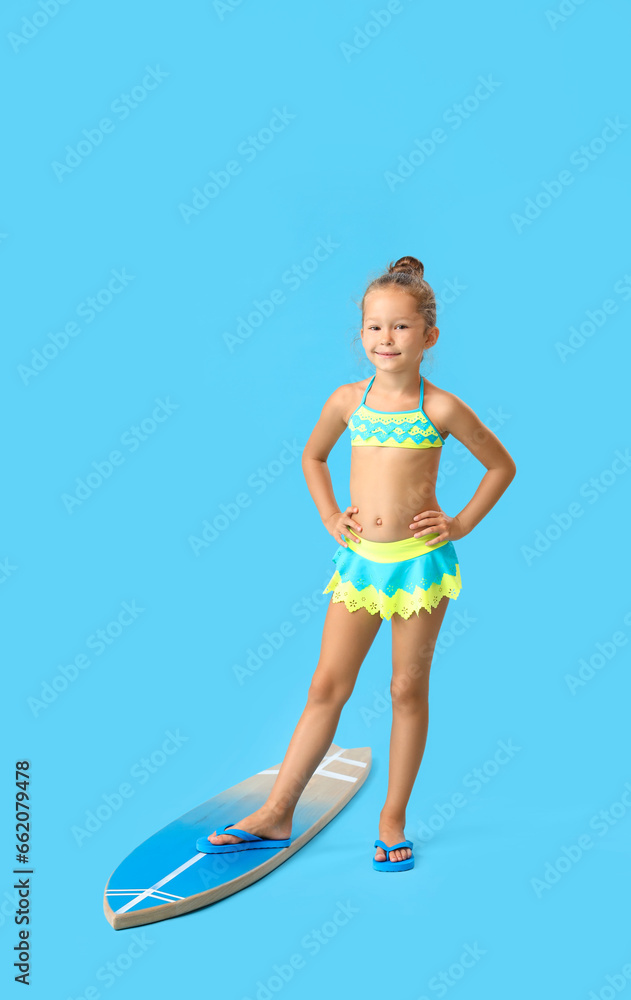 Little girl with surfboard on blue background