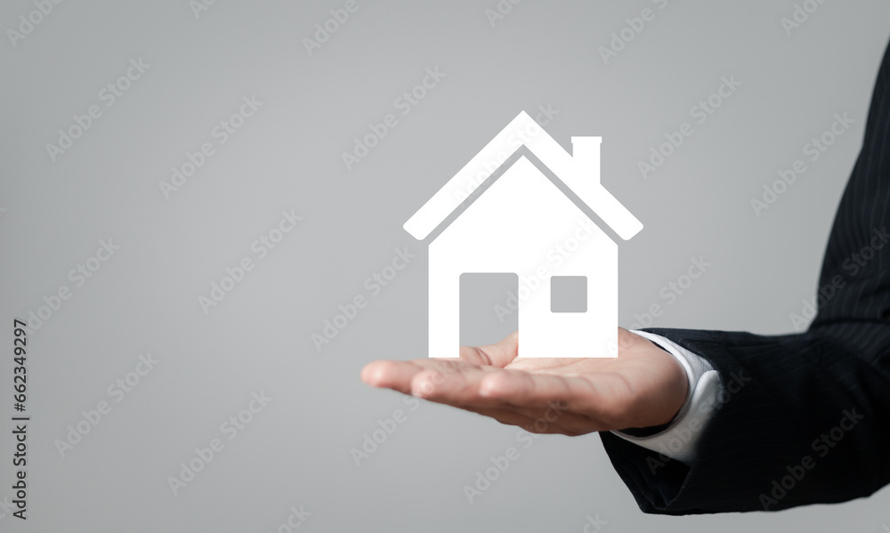 Real estate concept, Businessman showing house icon in hand for Property insurance and security concept.