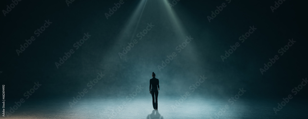 Back view of businessman walking in abstract dark wide interior. Education and smoke room concept.