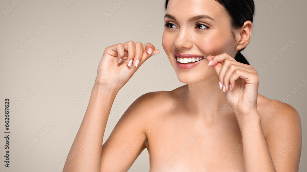 Positive young european woman brushing teeth with dental floss, enjoy lifestyle