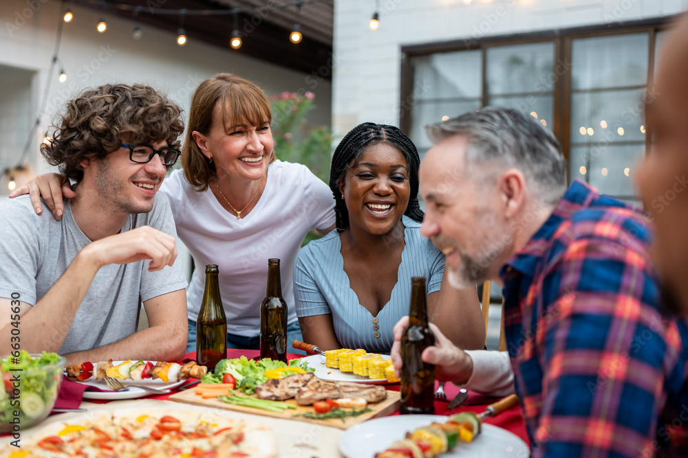 Multi-ethnic family having fun, enjoy party outdoors in the garden. 