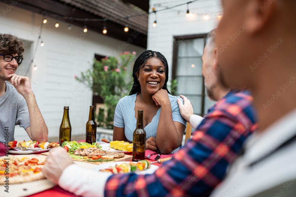 Multi-ethnic family having fun, enjoy party outdoors in the garden. 