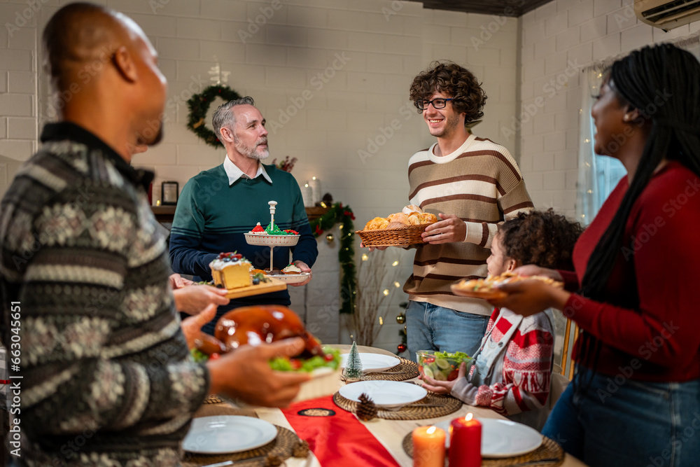 Multi-ethnic big family celebrating Christmas party together in house. 