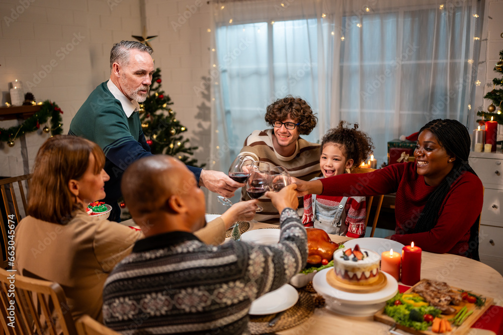 Multi-ethnic big family celebrating Christmas party together in house. 