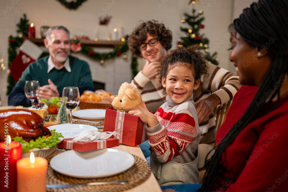 Multi-ethnic family exchanging presents during Christmas party at home. 