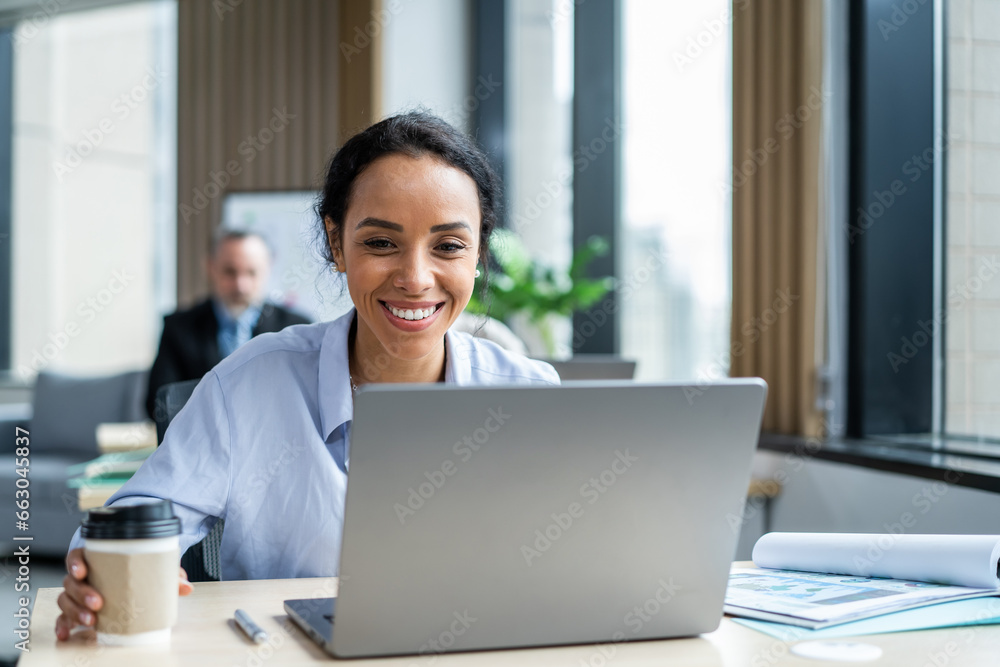 Latino beautiful businesswoman using laptop computer working in office. 