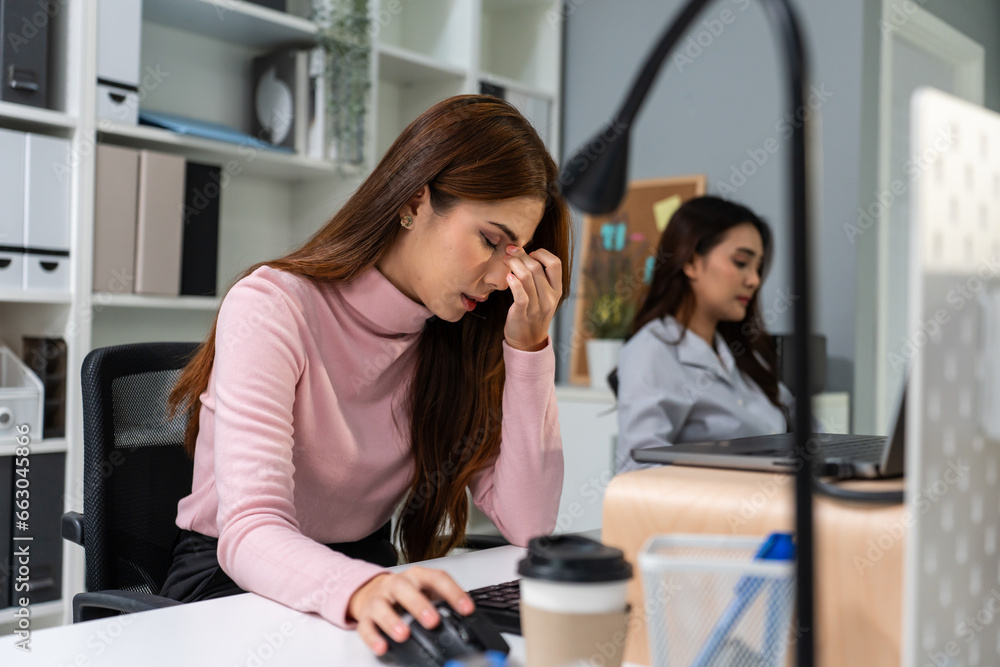 Exhausted Asian young businesswoman overwork late in office workplace. 