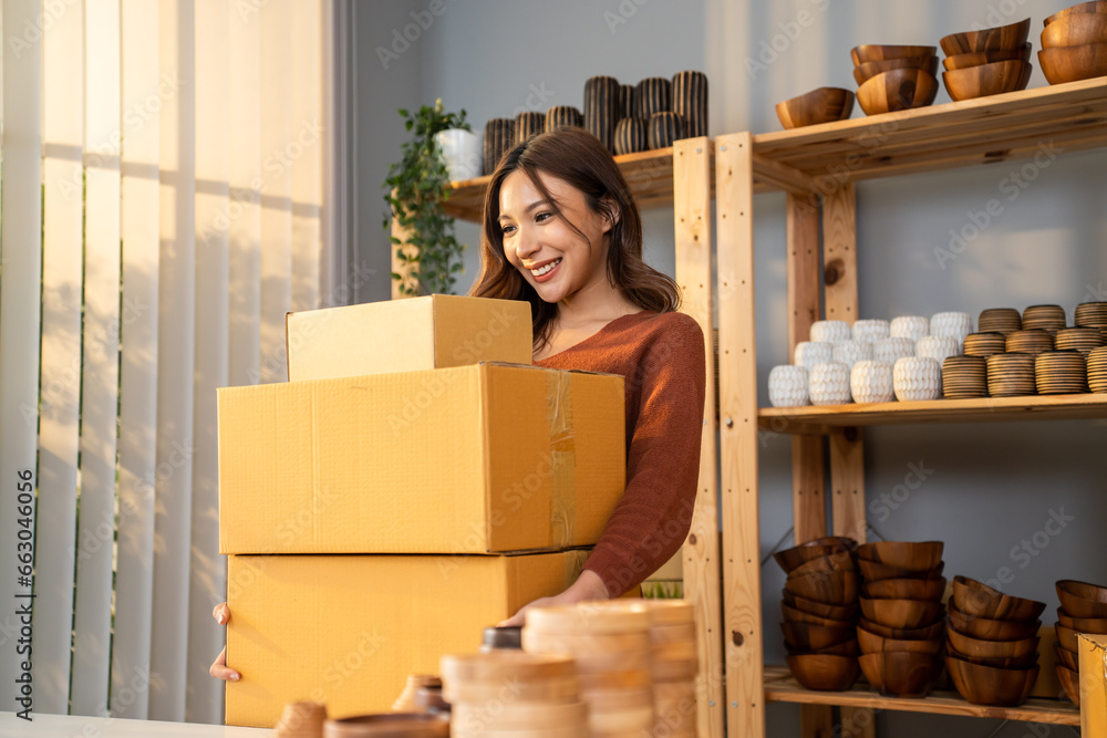 Caucasian young woman packing vase goods order into box for customer. 