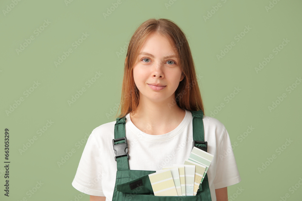 Female decorator with color samples on green background