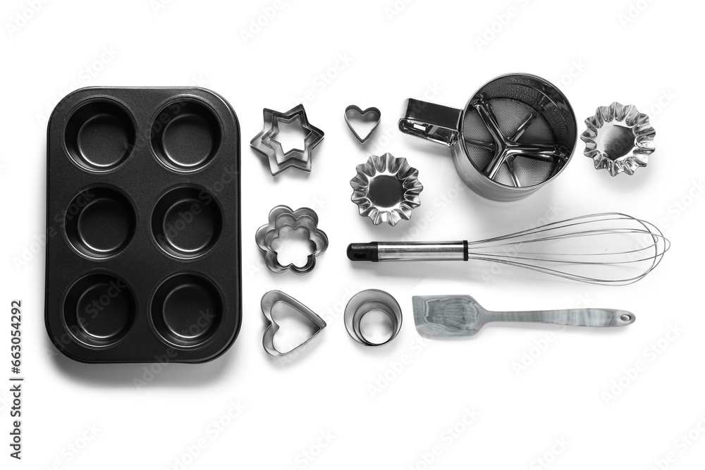 Baking utensils and cookie cutters isolated on white background