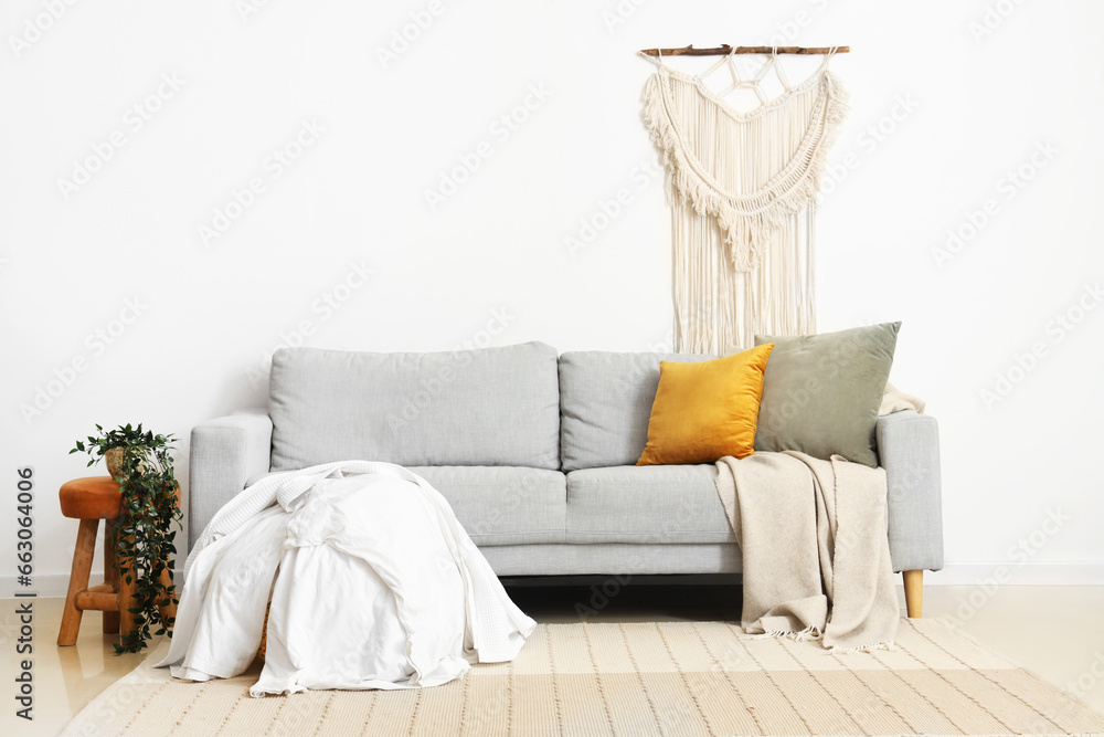 Interior of living room with sofa and dirty clothes