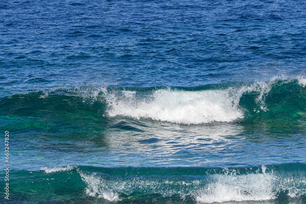 wave forming a tube, with the afternoon light, in the Atlantic Ocean