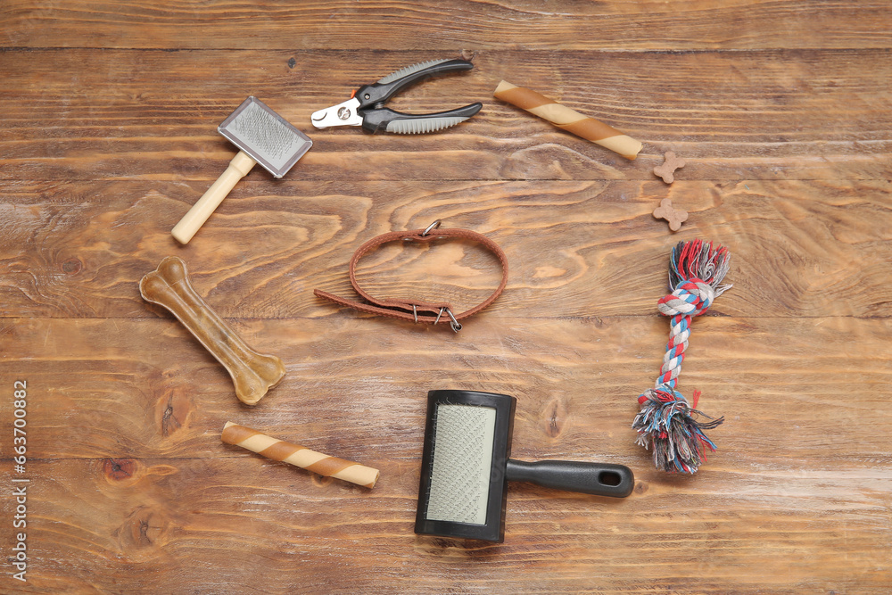 Composition with pet care accessories and food on wooden background