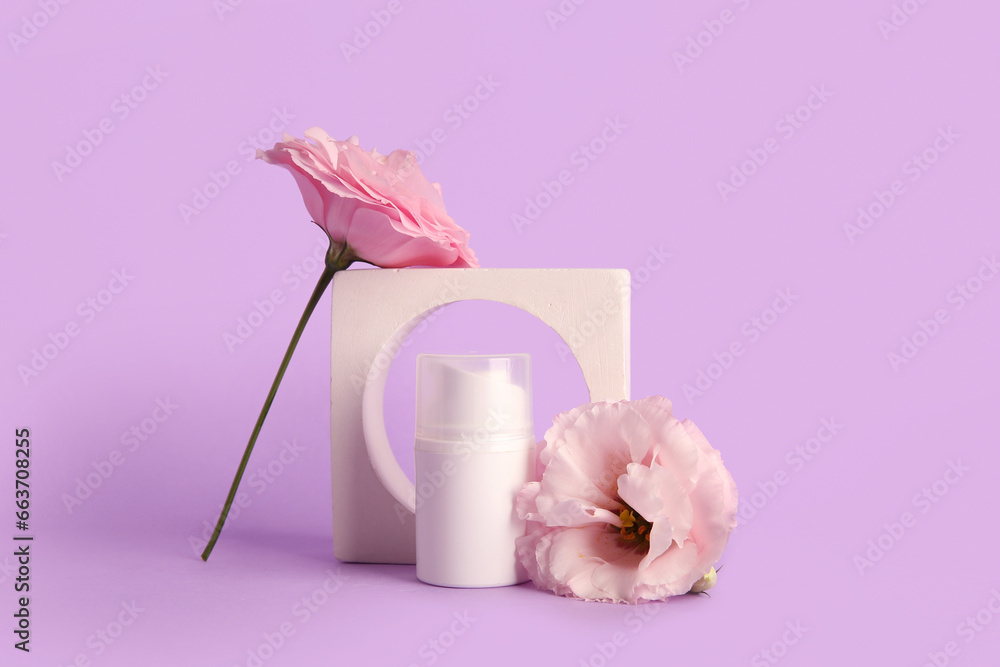 Composition with bottle of cosmetic product, plaster podium and beautiful eustoma flowers on purple background