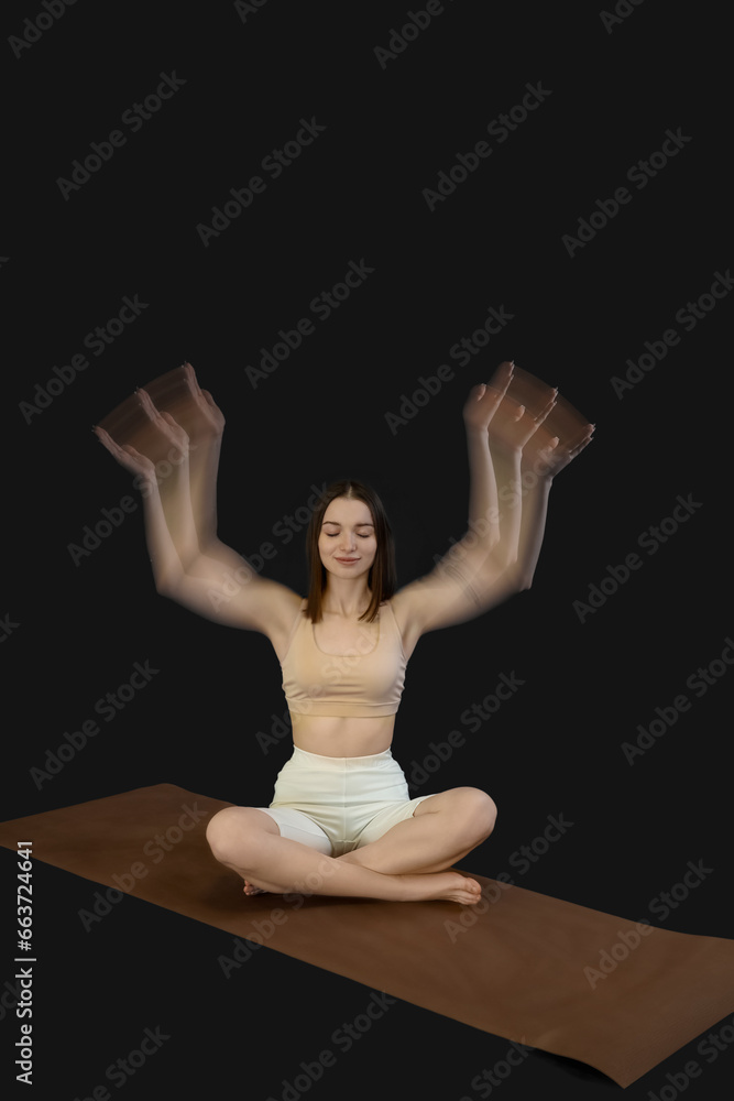 Portrait of young yoga trainer in motion on black background