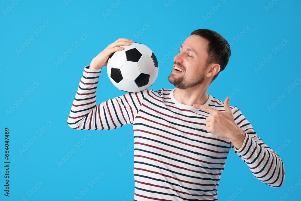 Man with soccer ball on blue background