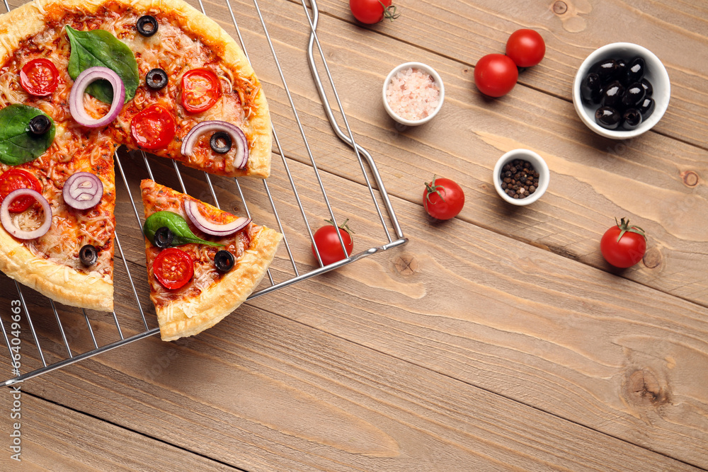 Stand of tasty pizza with basil and tomatoes on wooden background