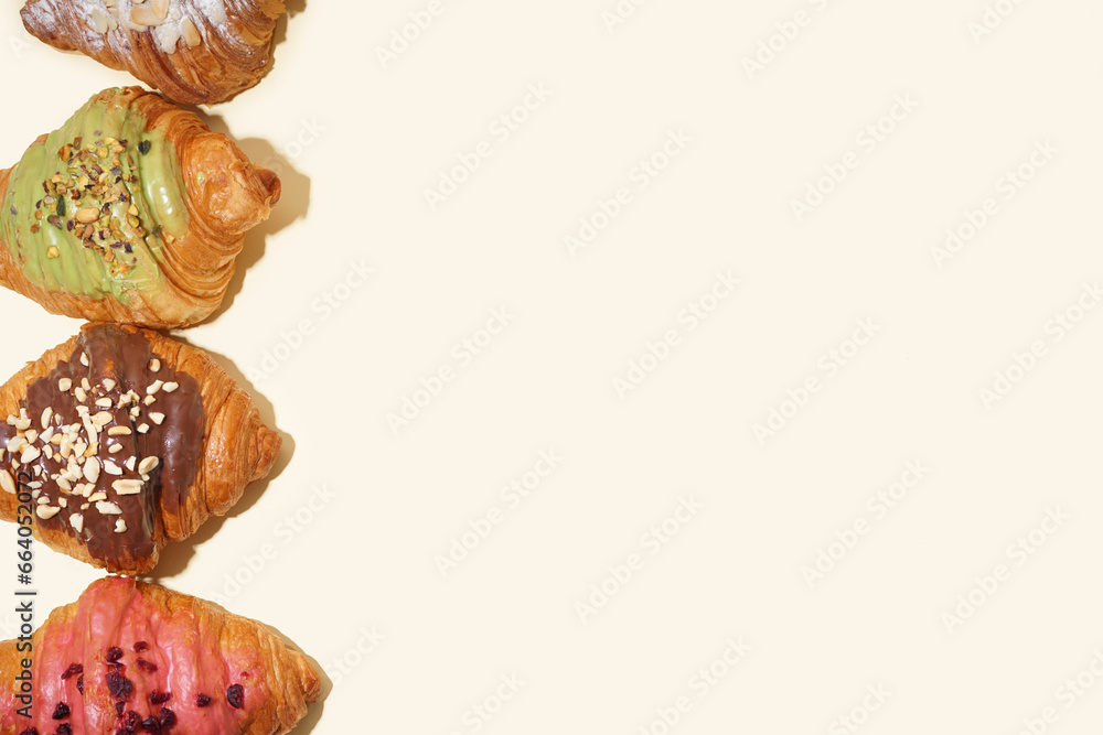 Different sweet croissants on light background