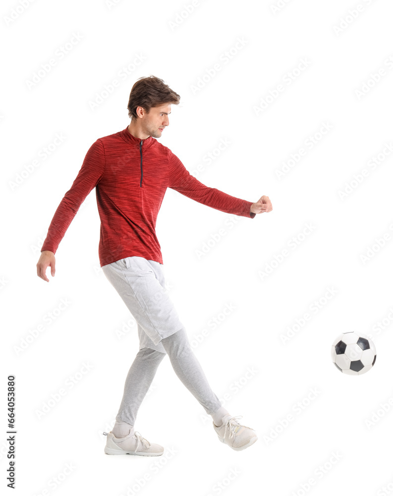 Handsome young man playing soccer on white background