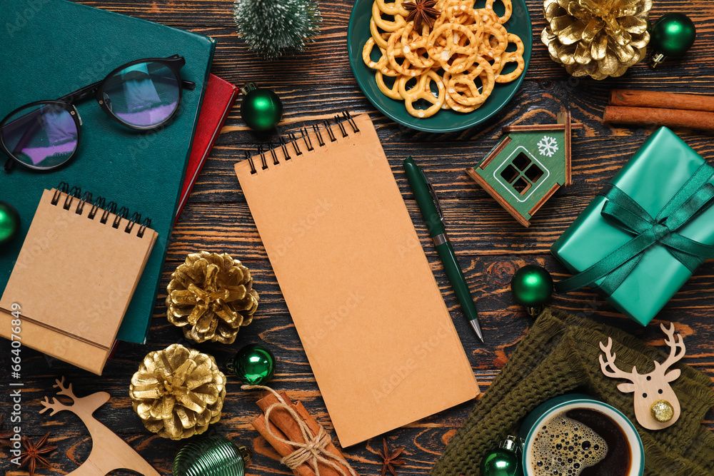 Christmas composition with blank notebooks, cup of coffee and decor on wooden background