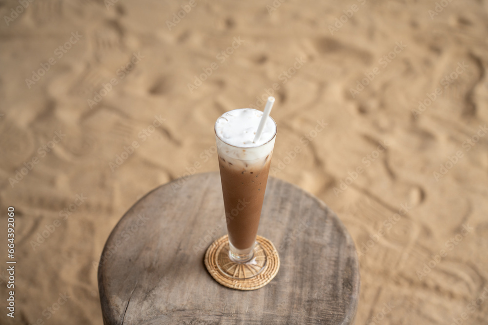 ice coffee latte glass of coffee cupucino on wood table background. Glass of a iced coffee with cream milk.