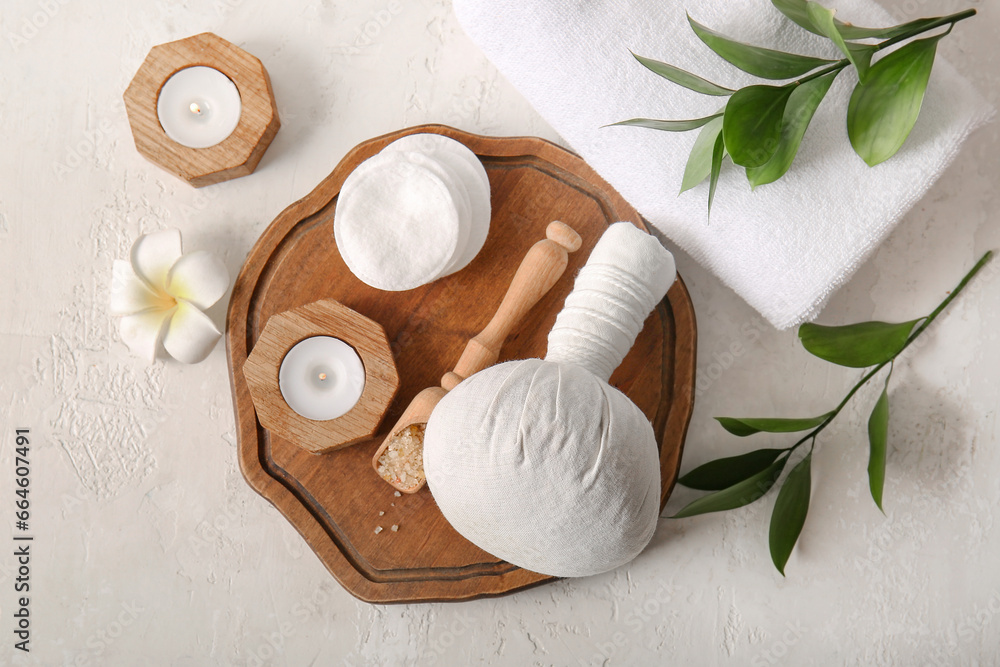 Composition with spa accessories and plant branches on light background