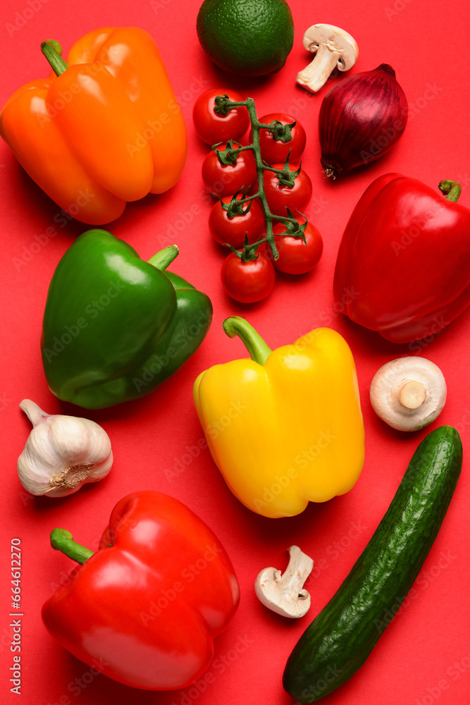 Fresh vegetables and fruits with mushrooms on red background