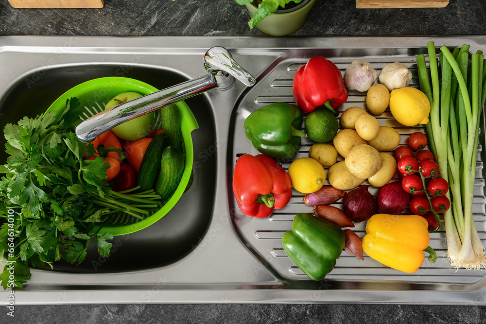 Fresh vegetables and fruits on metal sink