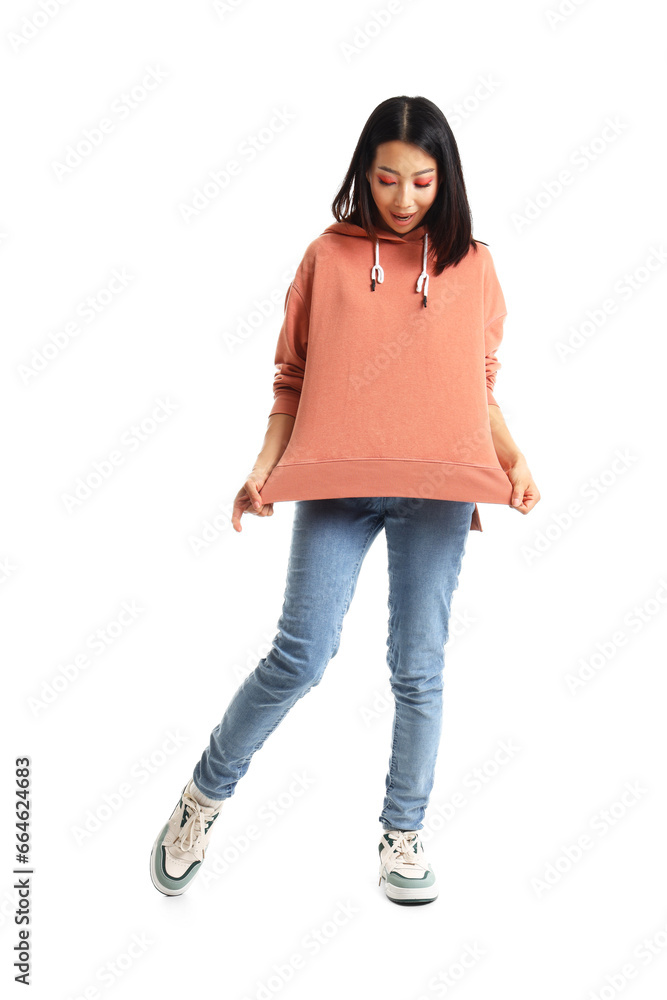 Young Asian woman in stylish hoodie on white background